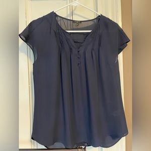 Delicate navy blouse with pleated and button detail.